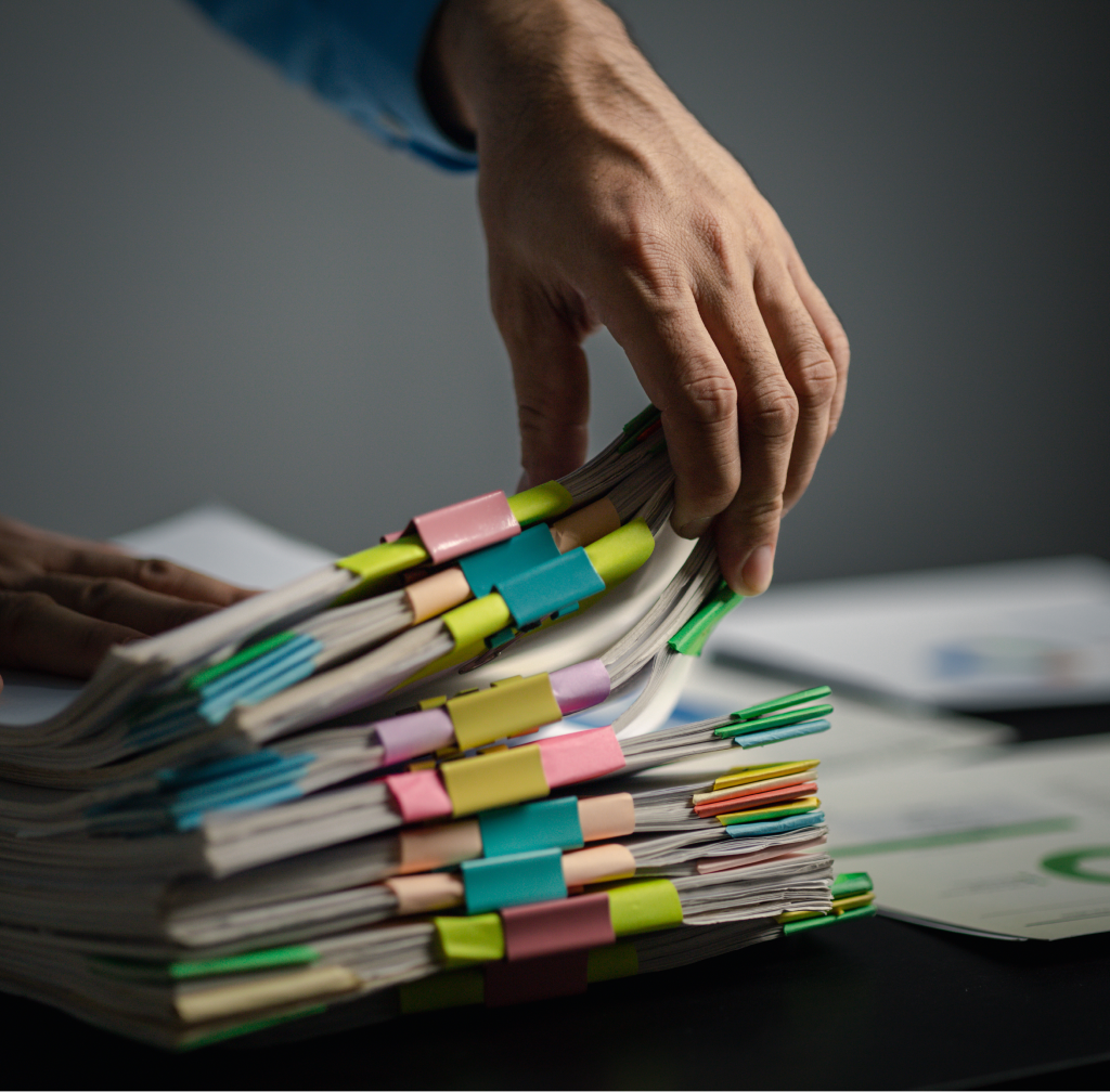 person-with-stacks-of-company-financial-report-pap-2023-11-27-04-52-09-utc 1